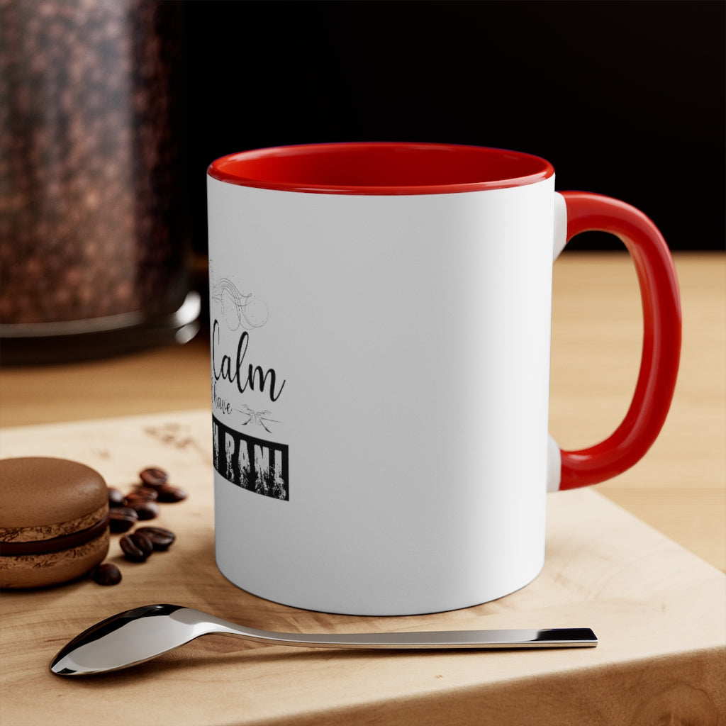White ceramic Keep calm and have hookah pani mug with red interior and handle on wooden surface with spoon and macaron