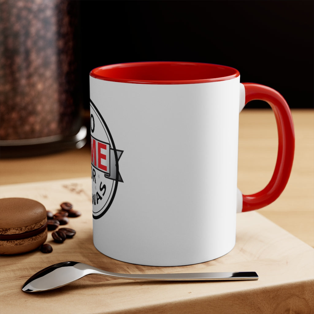 White ceramic mug with red handle and interior, partial "No time for bakwas" text visible, placed on wooden surface with spoon, coffee beans, and macaron nearby