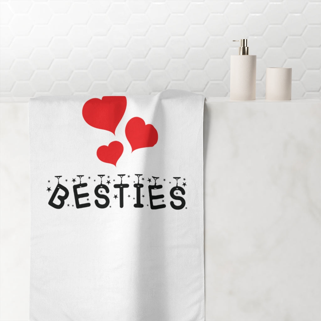 Premium towel with besties text and red hearts design hanging in bright bathroom setting