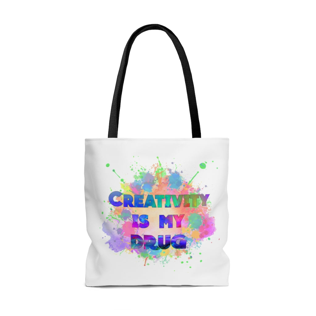 White AOP Tote Bag with black handles featuring colorful "Creativity is my drug" text and paint splatter design
