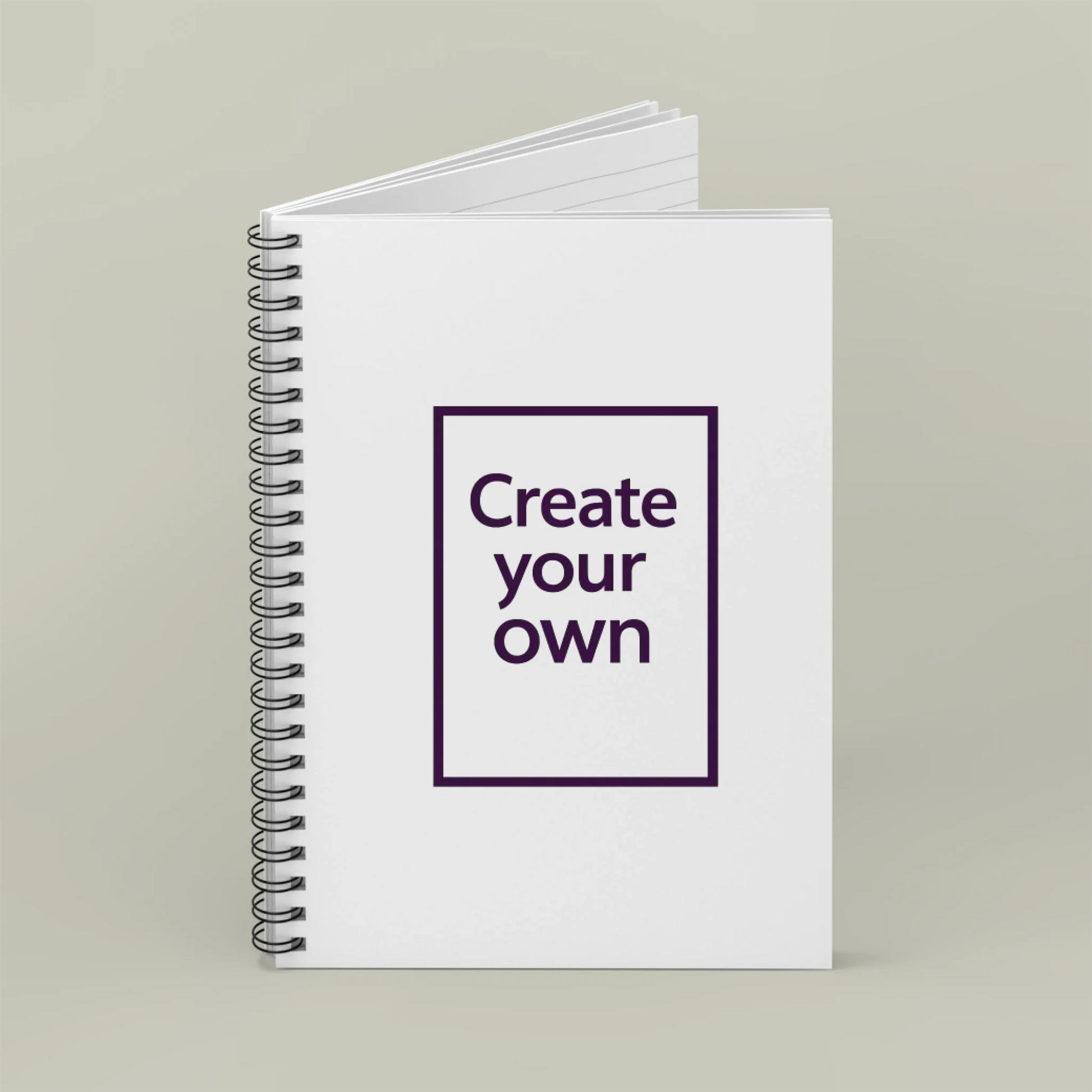 Notebook with 'Create your own' text on a plain background