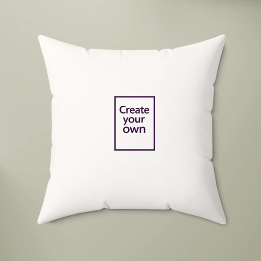 White pillow with a small square panel in the center that says 'Create your own' on a beige background